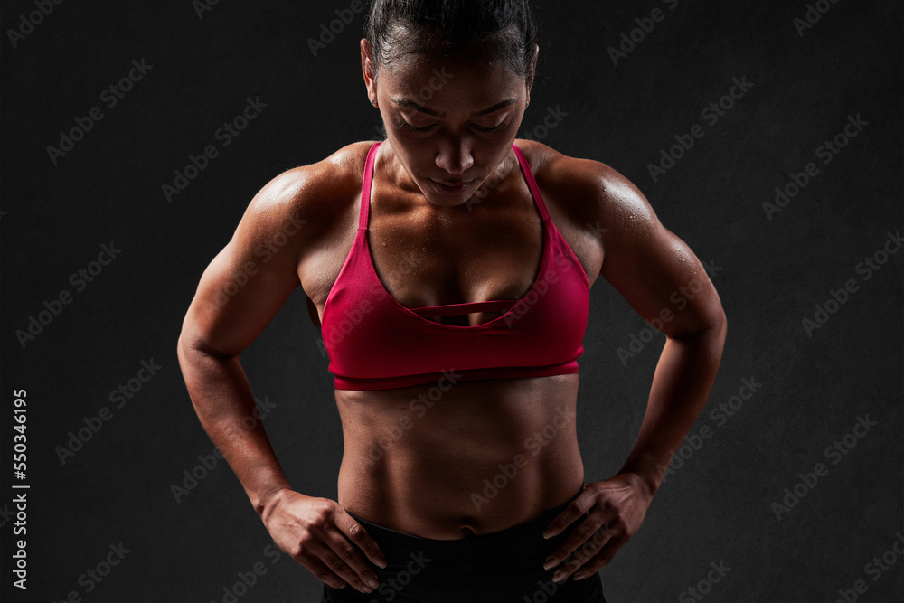 Muscular woman with hands on waist Muscular woman with hands on waist