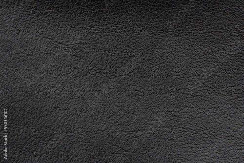 Black leather texture. Abstract background of dark leather with small roughness and scuffs