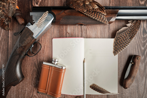 Fototapeta banner concept on the theme of hunting: a hunting rifle, a knife, a flask, woodc