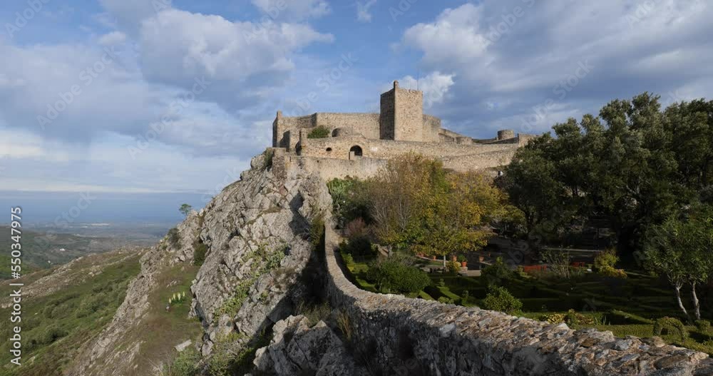 View of Marvao Castle during a sunny day with clouds. Historic Villages of Portugal. Old town inside of a fortified wall on the cliff of a mountain. Rural tourism. Holidays. Best destinations. View of Marvao Castle during a sunny day with clouds. Historic Villages of Portugal. Old town inside of a fortified wall on the cliff of a mountain. Rural tourism. Holidays. Best destinations.