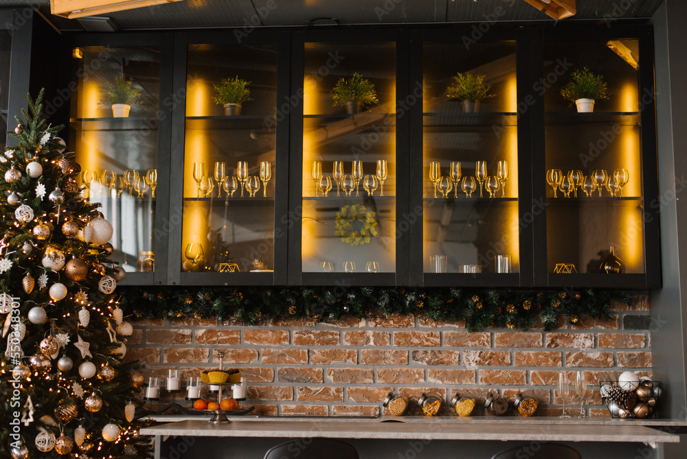 Festive dining room in Christmas decorations. Christmas dining room. Beautiful Christmas decor in the loft style of home interior. Festive dining room in Christmas decorations. Christmas dining room. Beautiful Christmas decor in the loft style of home interior.