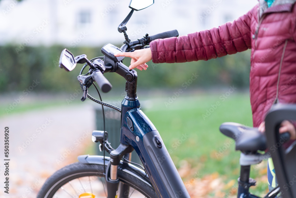 Crop woman using bike computer on street Crop woman using bike computer on street
