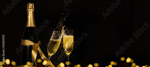Luxury celebration birthday new year's eve sylvester or other holidays background banner greeting card - Toast with sparkling wine or champagne glasses and bottle on dark black night background