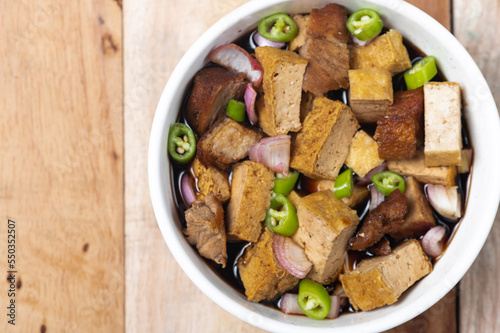 Tokwa't baboy is a typical Philippine appetizer or pulutan. It consists of pork ears, pork belly and deep-fried tofu, and is served in a mixture of soy sauce, pork broth, vinegar, chopped white onions photo