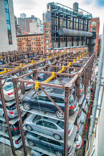 Outdoor car parking in a big city. Stacker parking system storing vehicles on platforms that can be raised, lowered and shuffled around