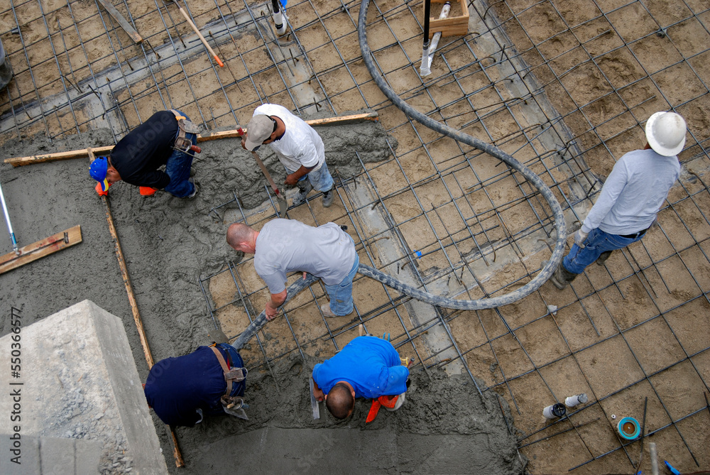 Pouring a large concrete slab on a construction project, high angle view Pouring a large concrete slab on a construction project, high angle view