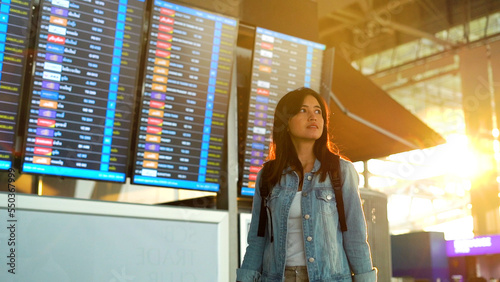 Asian traveler woman walking in airport terminal. photo