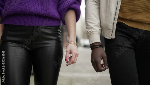Interracial couple walking together in city sidewalk2
