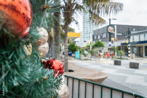 Takapuna streets in Christmas decoration, out-of-focus shops and people in the background. Auckland photo
