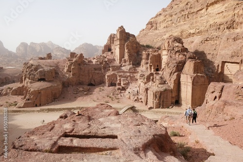 Silhouettes of people on trail in Petra, Jordan. Petra is ancient Nabataean city, considered one of seven new wonders of world and is world heritage site.