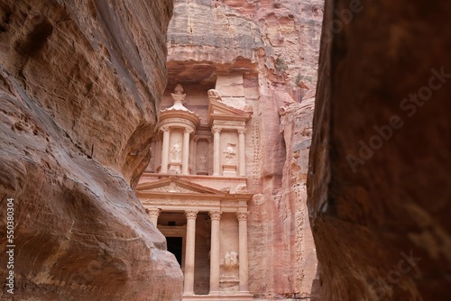 Famous Treasury in Petra, Jordan. View between walls of narrow gorge al-Siq. Petra is considered one of seven new wonders of world and is world heritage site.