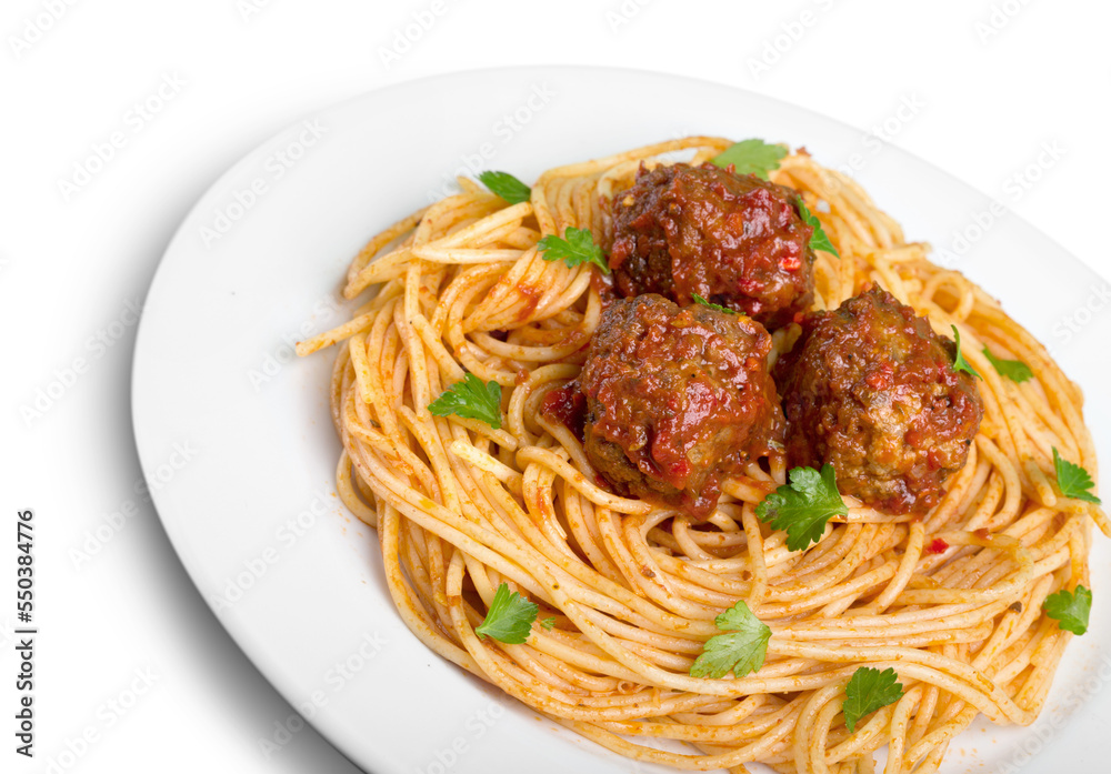 Spaghetti pasta with tomatoes and basil on white plate Spaghetti pasta with tomatoes and basil on white plate
