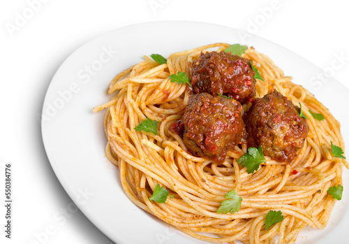 Spaghetti pasta with tomatoes and basil on white plate