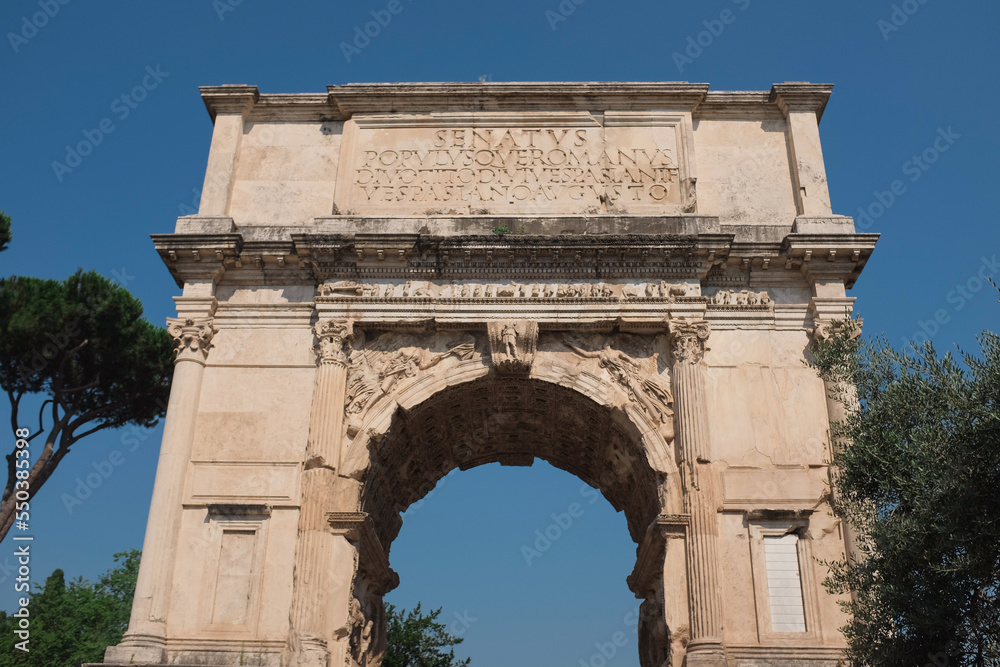 Rome, Italy - Arch of Titus ruins along the Via Sacra in the Roman Forum. Ancient structure celebrating fall of Jerusalem. Symbol of Jewish diaspora. Inspiration for Arc de Triomphe. Famous landmark.