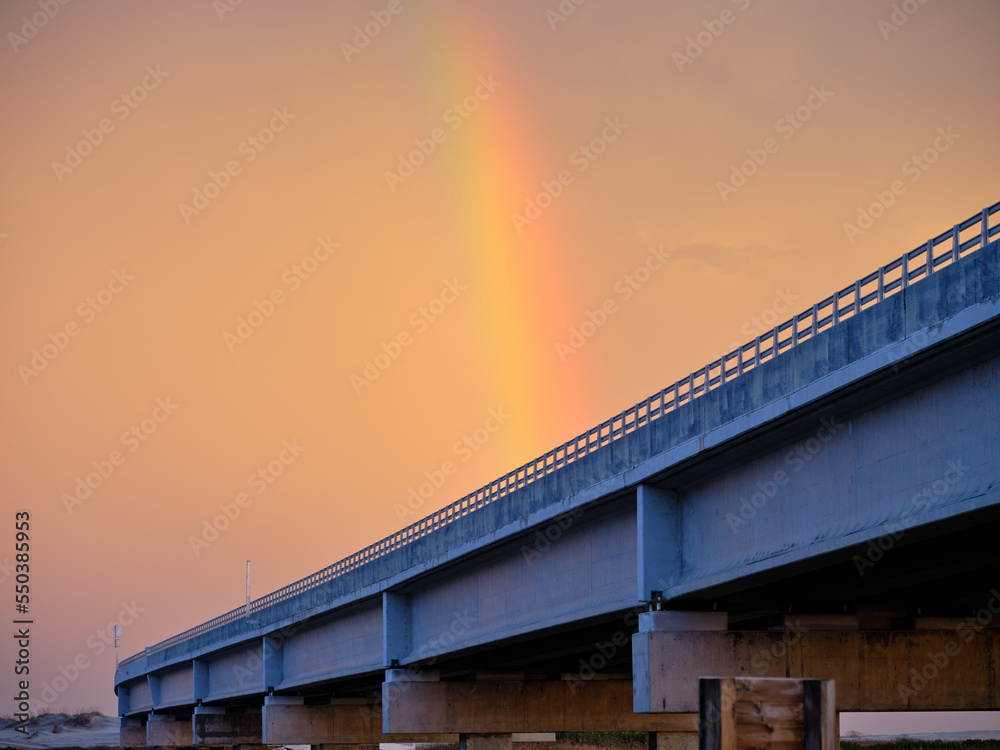 Colorful Rainbow at sunset over the Herbert C Bonner new bridge over Oregon Inlet on the Outer Banks of North Carolina