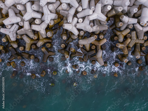 Aerial drone view of a breakwater. breakwater in the sea, a collection of concrete breakers