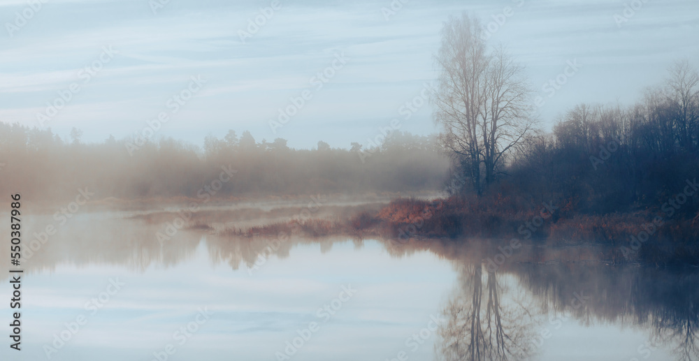 Fototapeta premium Misty morning over the river. picturesque view in nature