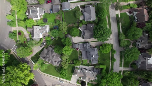 Upper class estate and nearby homes and driveways with lawns among large suburbia sprawl at Upper Arlington high income neighborhood and suburb outside Columbus, Ohio in the Midwest, United States