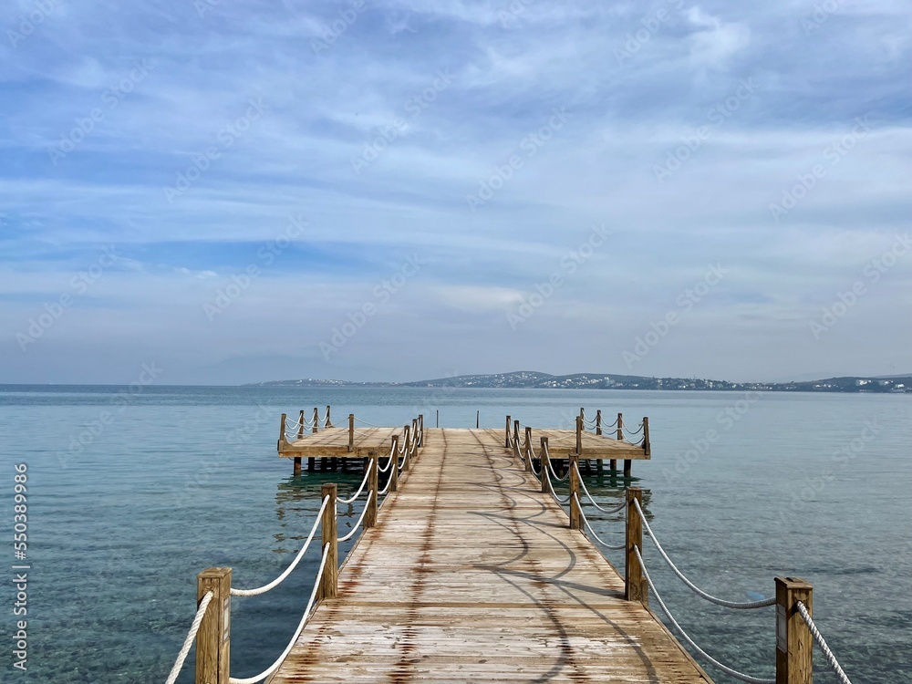 Beautiful wooden pier at the sea, sea horizon Beautiful wooden pier at the sea, sea horizon