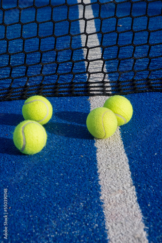 selective focus, four balls at the net on a paddle tennis court. Racket sports © Vic