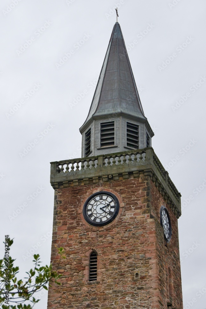 Church tower with clock standing in Highland Scotland