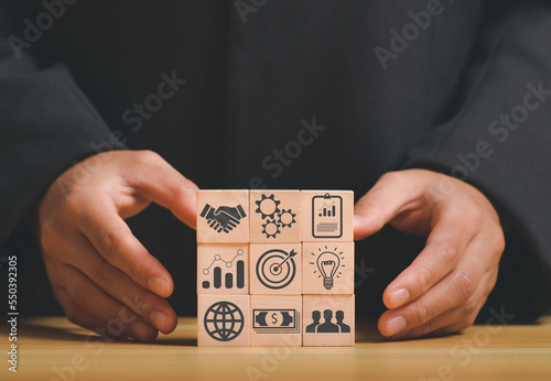 business strategy, Action plan, Goal and target, hand stack woods block step on table with icon about business strategy and Action plan. business development concept. copy space