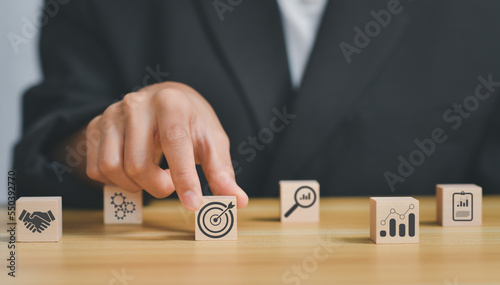 business strategy, Action plan, Goal and target, hand stack woods block step on table with icon about business strategy and Action plan. business development concept. copy space