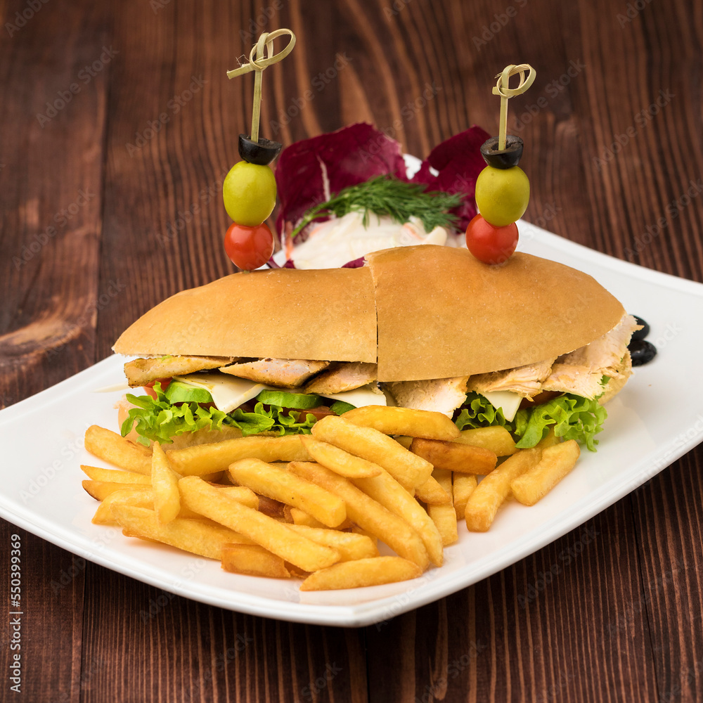 Obraz premium California chicken sandwich with french fries served in dish isolated on table top view of fastfood