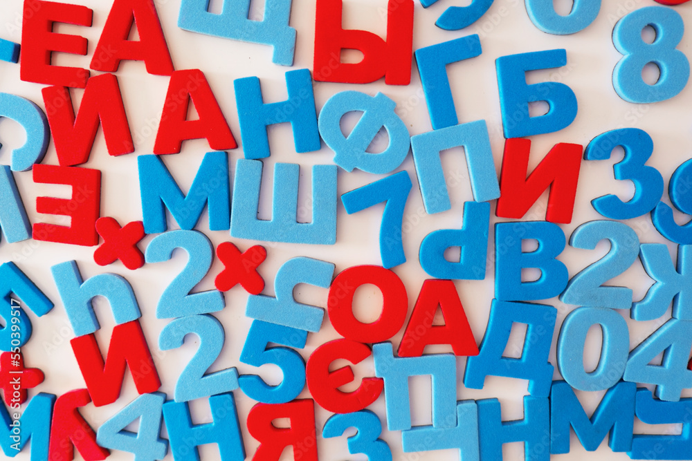Russian letters and numbers. Red vowels and blue consonants on a white background. High quality photo.