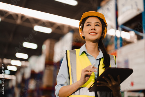 Portrait of Asian woman warehouse supervisor working distribution warehouse to and managing inventory and logistics.