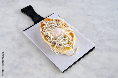 table with a toast of eels and fried egg