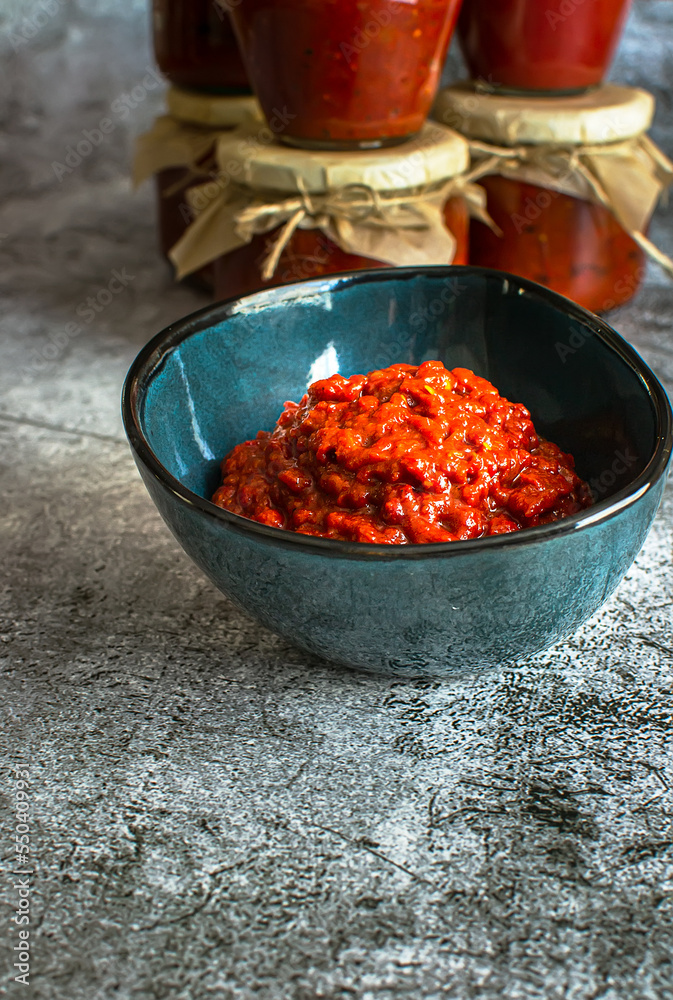 A bowl of homemade lutenica and jars of the same A bowl of homemade lutenica and jars of the same