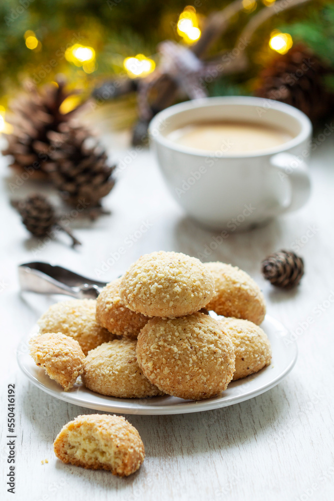 Christmas nut cookies Filbertines served with coffee on a background of Christmas decorations.