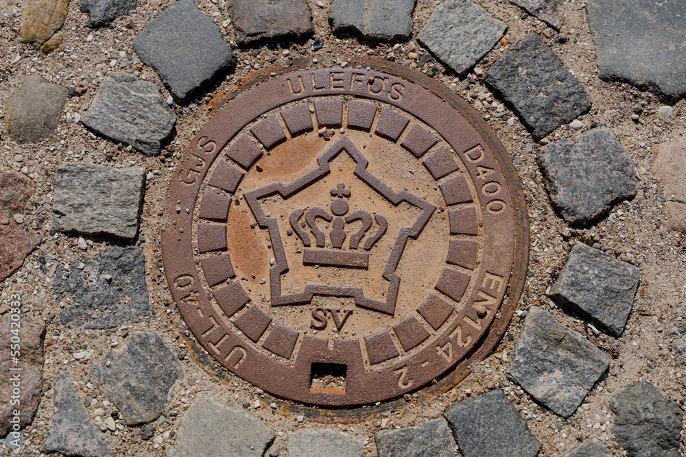 Sewer hatch. Sewer manhole with coat of arms of the Kingdom of Denmark.