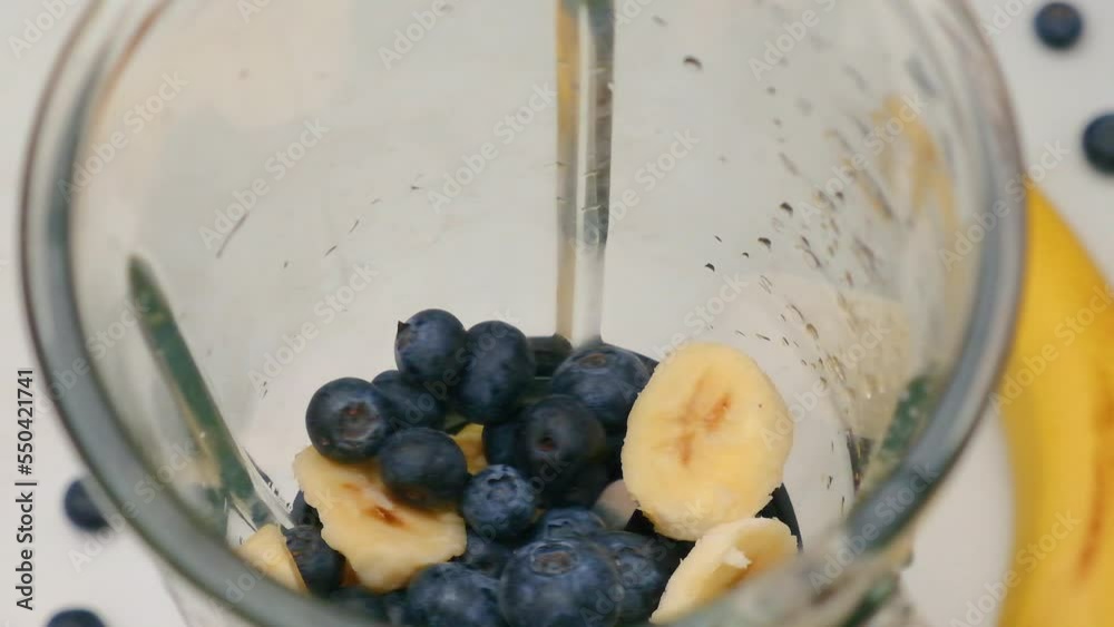 Cooking blueberry and banana smoothie or milkshake in blender. Fruits