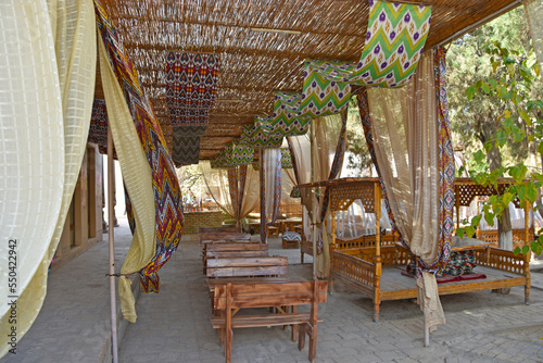 outdoor cafe with a wicker roof and oriental patterns in the old town of Khia in Uzbekistan © Anton Perekrestov