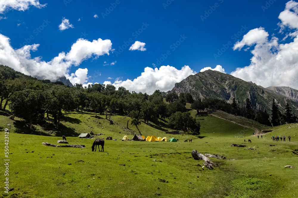 Beautiful mountain scenery. River, valley, snow, blue sky, white clouds. In-depth trip on the Sonamarg Hill Trek in Jammu and Kashmir, India