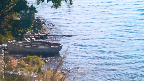 Wooden rowing cockboat (old vessel) on the shore of Lake Baikal. Siberia photo