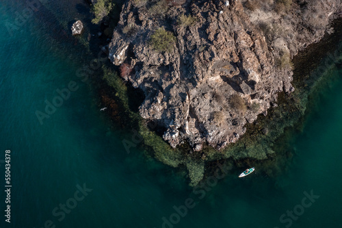 A woman paddles around a bay off the coast of Baja in the Sea of Cortez photo
