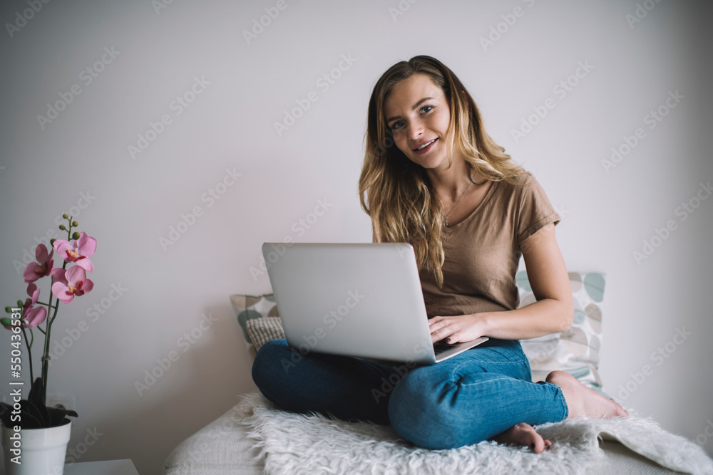 Portrait of millennial female freelancer with modern netbook doing distance jog using wireless internet connection for PC projecting, skilled woman with laptop computer looking at camera indoors Portrait of millennial female freelancer with modern netbook doing distance jog using wireless internet connection for PC projecting, skilled woman with laptop computer looking at camera indoors