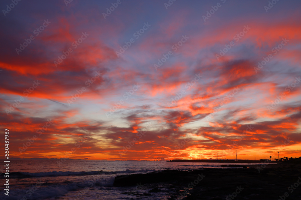 Sunset sky clouds over the sea in Apulia, Italy. Beautiful sunlight in the ocean. Amazing nature landscape seascape Colorful sky clouds background.