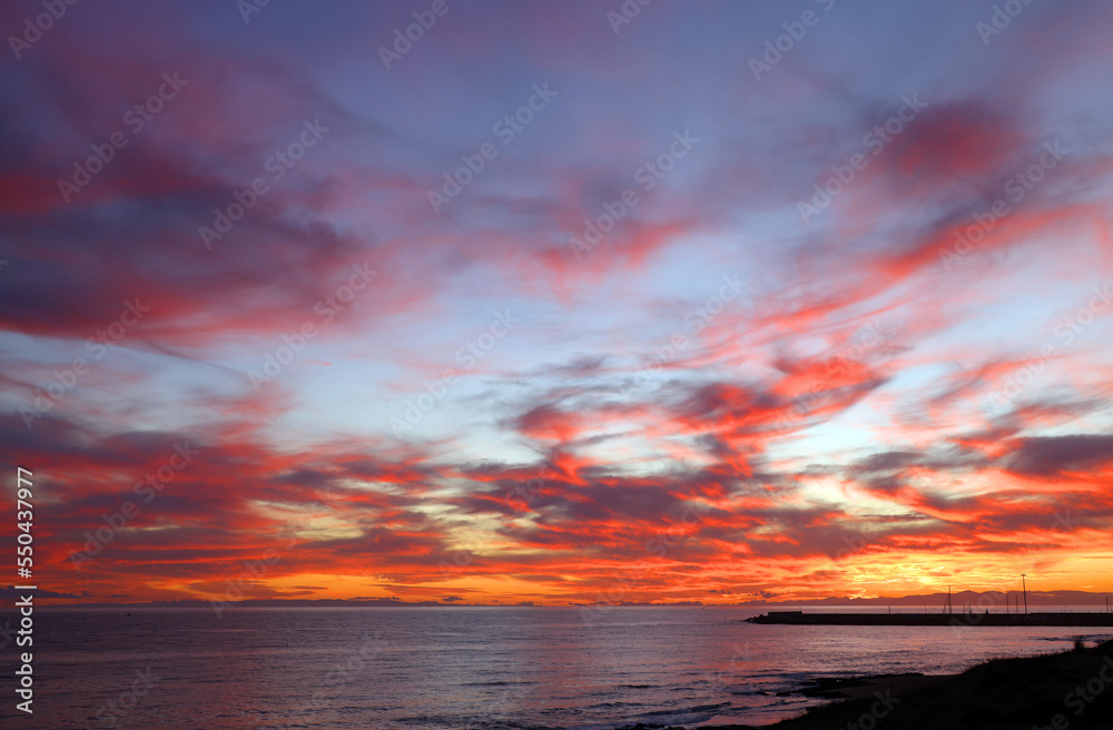 Sunset sky clouds over the sea in Apulia, Italy. Beautiful sunlight in the ocean. Amazing nature landscape seascape Colorful sky clouds background.