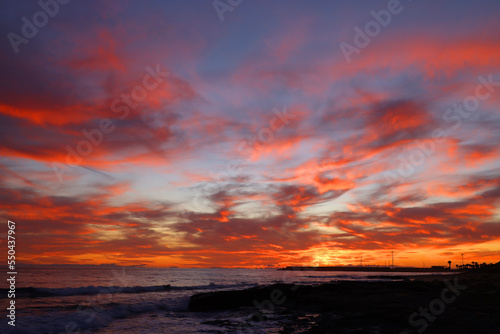 Sunset sky clouds over the sea in Apulia  Italy. Beautiful sunlight in the ocean. Amazing nature landscape seascape Colorful sky clouds background.