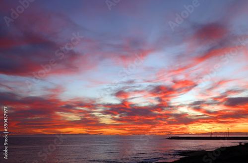Sunset sky clouds over the sea in Apulia  Italy. Beautiful sunlight in the ocean. Amazing nature landscape seascape Colorful sky clouds background.