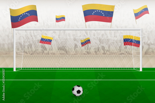Venezuela football team fans with flags of Venezuela cheering on stadium, penalty kick concept in a soccer match.