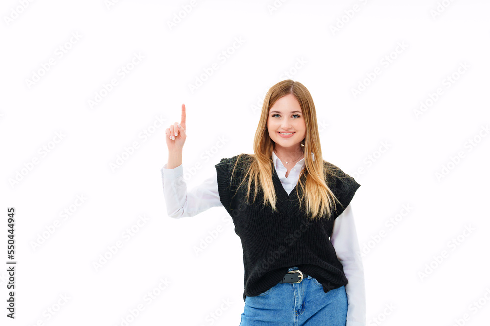a blonde in a black vest shows fingers up on a white background a blonde in a black vest shows fingers up on a white background