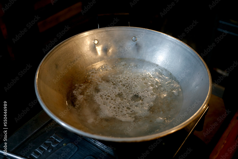 Boiling water in the pan at night. 