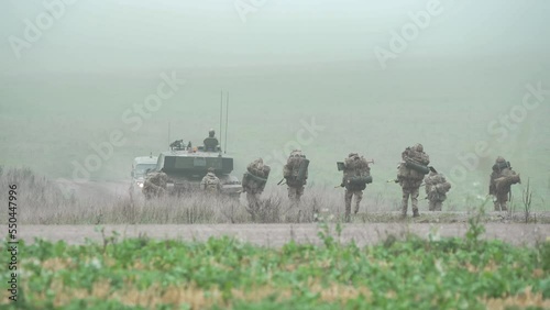 British army FV4034 Challenger ii 2 main battle tank passes an infantry troop unit on a 40kg loaded march tab military exercise, Wiltshire UK