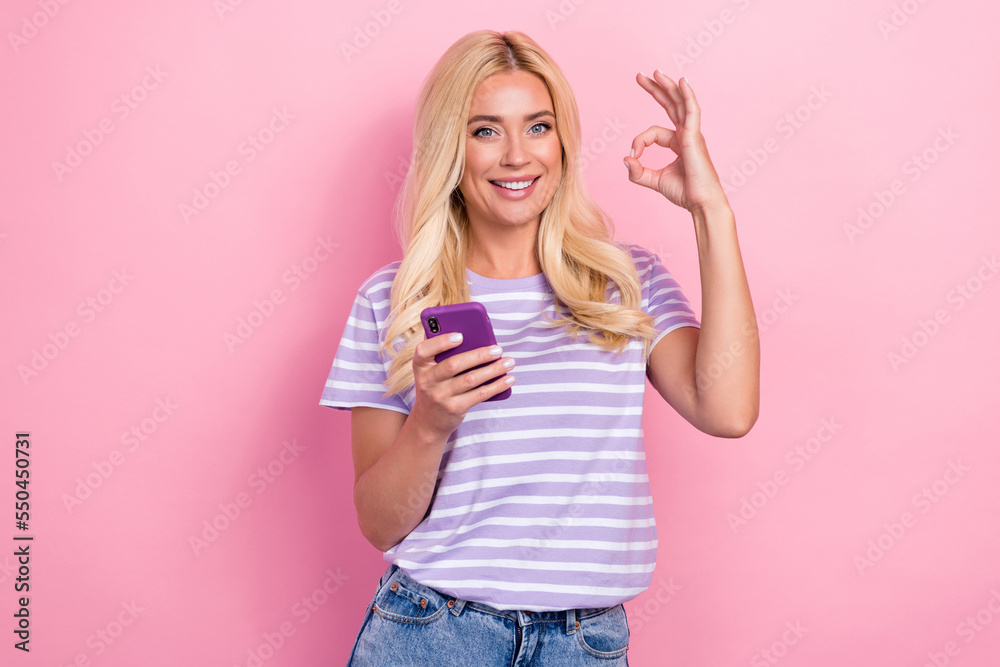 Photo of positive cheerful cute lady raise hand okey symbol satisfied quality good price isolated on pink color background Photo of positive cheerful cute lady raise hand okey symbol satisfied quality good price isolated on pink color background