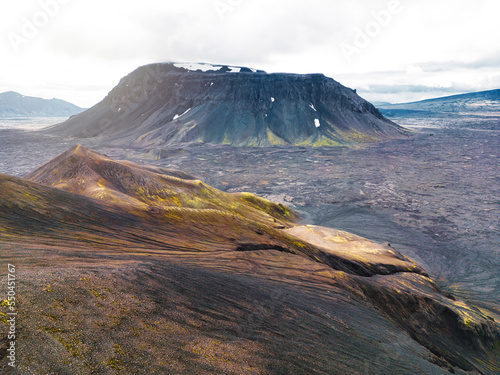 Mountain rising from the flat volcanic lands in Iceland - Cloudy day in autumn